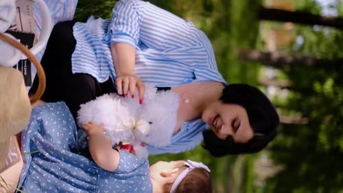 Mother and child together in the park outdoors, lying in the grass. Motherhood happiness concept. Da