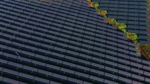 Flight over the huge area with numerous solar panels.