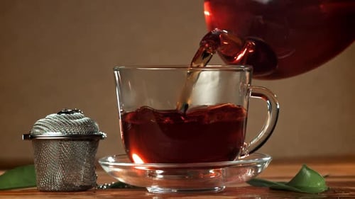 Steaming Tea Pours into Glass Cup
