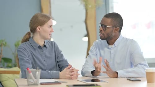 Young Business People Discussing Work in Office