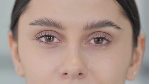 Close Up of Blinking Eyes of Young Woman