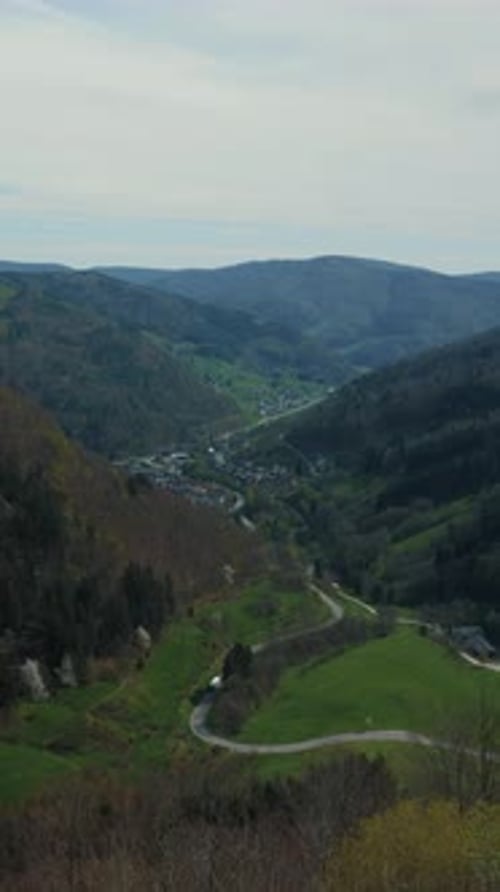 Mountain landscape with village valley and meadows. Vertical video