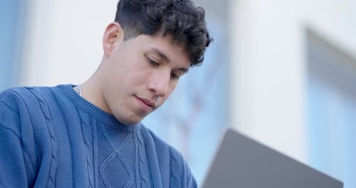Young Adult Working on Laptop Outdoors