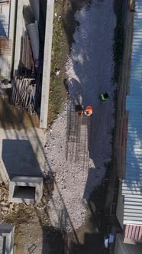 Vertical Video Teams on a Large Construction Project Performing Various Tasks Including Metalwork