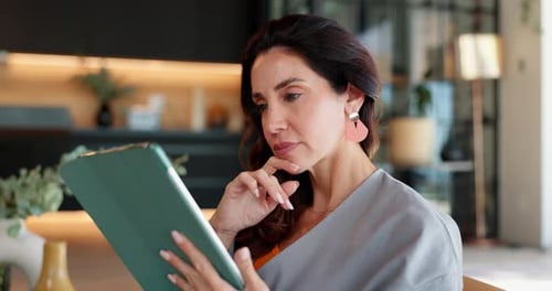 Woman Uses Tablet Device Indoors During Daytime