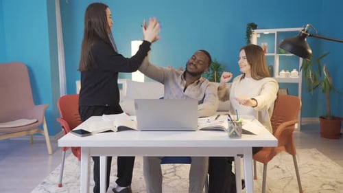 College teenagers looking at laptop and rejoicing at home.