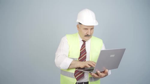 Engineer working on project on laptop.