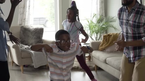 Family Dancing in Living Room with Cheerful Energy