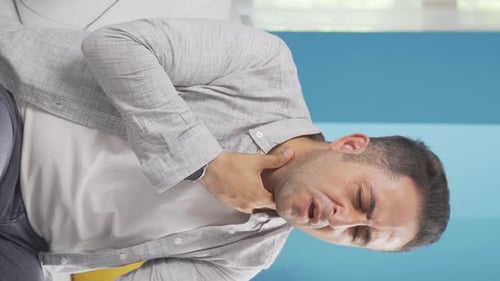 Man With Throat Pain Sits on Sofa