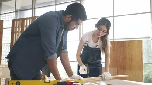 Man and Woman Working Together in a Workshop