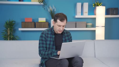 Man typing or working using laptop is amazed and disappointed about the news and messages he sees.