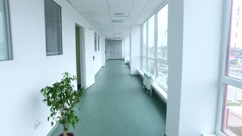 Point of view walking through a clean white laboratory corridor