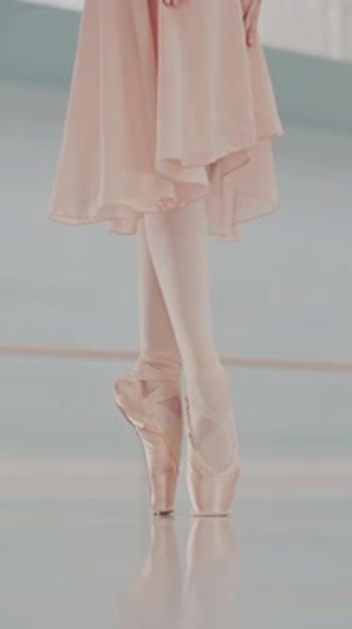Close Up of Ballerina Feet in Pointe Shoes Dancing Gracefully. Female Classical Ballet Dancer legs.