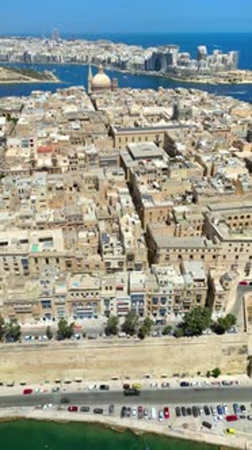 Aerial drone view of the walled city of Valletta, Malta, surrounded by the Mediterranean sea in dayl