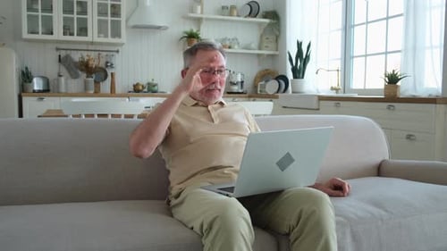 Adult Man on Laptop Video Call at Home