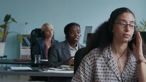 Customer Support Representatives Consulting Online Clients and Taking Notes