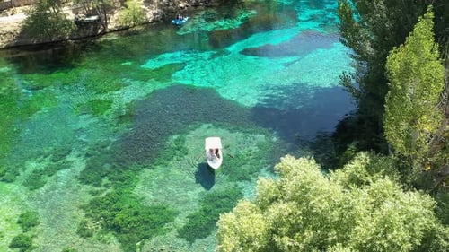 Aerial View Of People Cruising By Boat On The Lake