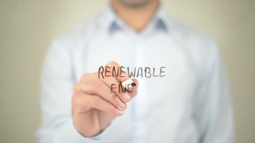 Writing Renewable Energy with Marker on Clear Surface
