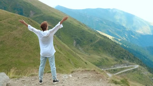 Woman Celebrating Reaching Mountain Summit