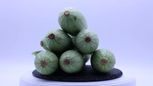 Fresh green zucchini rotating on a turntable.