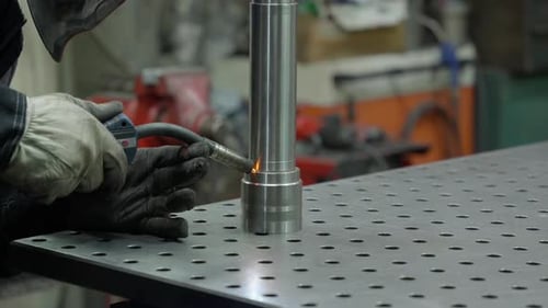 Welder Joining Metal Parts Using Welding Tool in Workshop