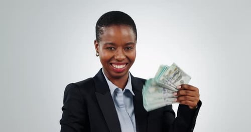 Success, money fan and face of black woman in studio for invest, loan or payment on grey background