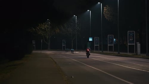 Lone cyclist at night near Jarun Lake, Zagreb