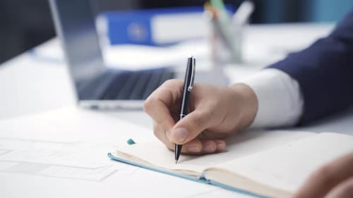 Close-up businessman hands working on laptop.