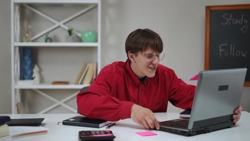 Young Adult Attending Online Class on Laptop