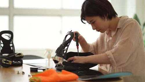 Woman taking care of snowboard board