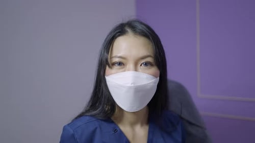 Woman Wearing Protective Face Mask in Clinic