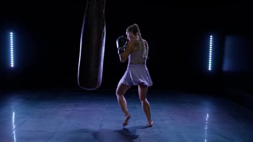 Kickboxing Woman Fighter Beats a Punching Bag Training Day in the Boxing Gym Pro Fighter Trains His