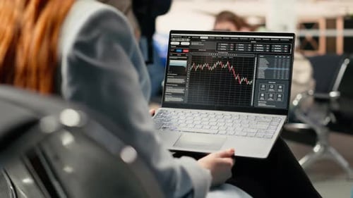 Professional Woman Reviewing Stock Charts and Financial Market Insights