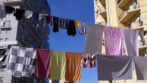 Clothes Hanging and Drying on a Rope on a Multistory Building in a Poor District of the City