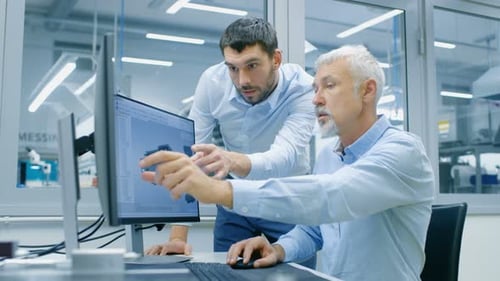 Engineers Collaborate on 3D Model at Computer