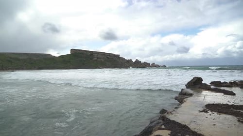 High Tides are Rolling in Ghajn Tuffieha Bay on a Gloomy Cloudy Windy Day in Malta