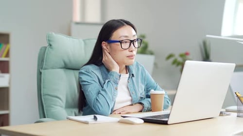 Young Woman Working at Desk with Laptop