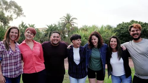 Smiling Friends Standing Together in a Green Park