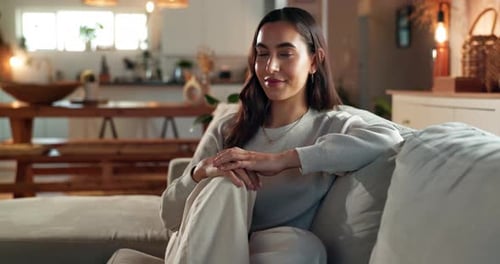 Woman Resting Comfortably on Sofa Indoors
