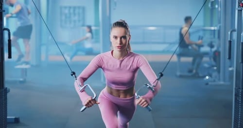 Zoom Portrait of Young and Strong Fitness Woman Engaged in Sports Exercising Intensively at the Gym