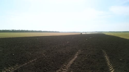 Tractors plowing the field in Ukraine