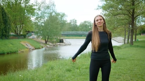 Young Cheerful Woman Dancing By River Making Simple Moves Joyful Female Moving Gracefully Near Water