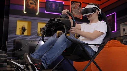 Man Using VR Headset and Racing Wheel