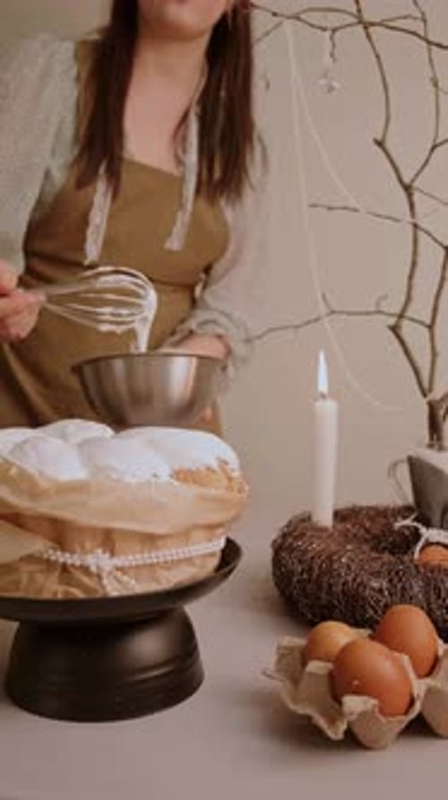 Woman Prepares Cake Icing in Kitchen with Easter Decor
