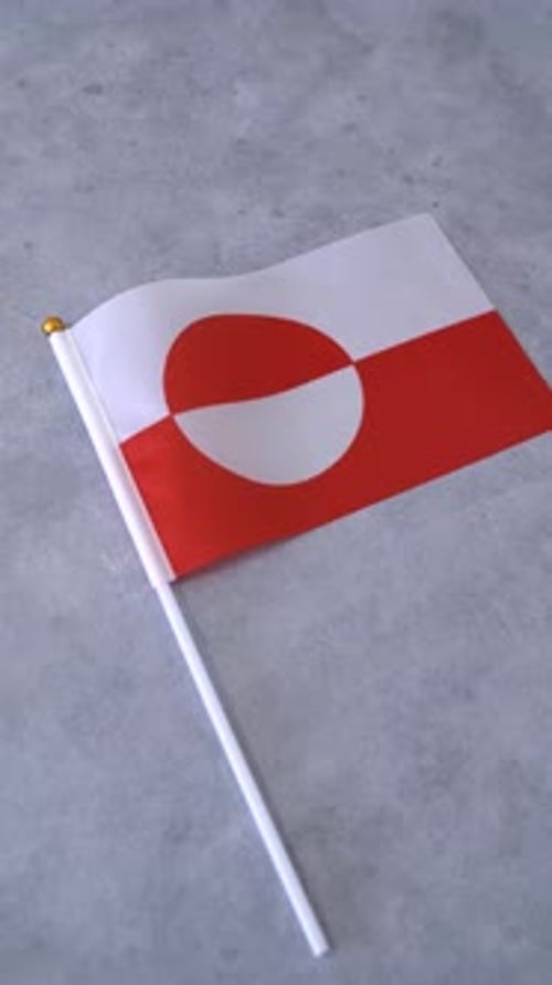 Greenland Flag Waving on Gray Surface in Studio Shot