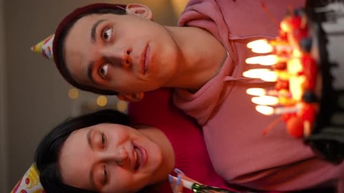 Young Couple Celebrating Birthday with Cake and Candles