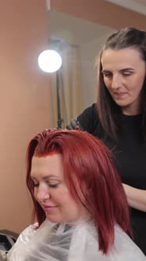 Woman Receiving Hair Dye Treatment at Salon