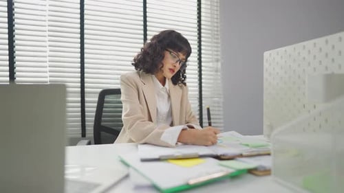Frustrated Asian young businesswoman overwork late in office workplace.
