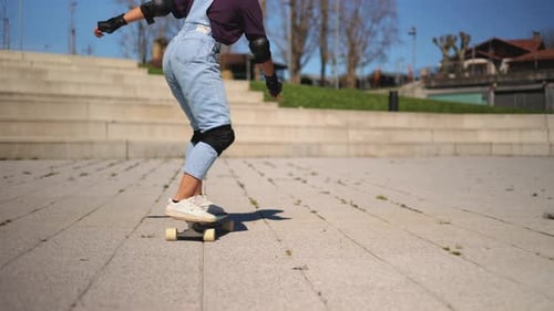 Latin woman surfskating in a pump track