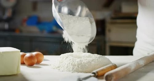 Flour Being Poured onto Dough Preparation Table